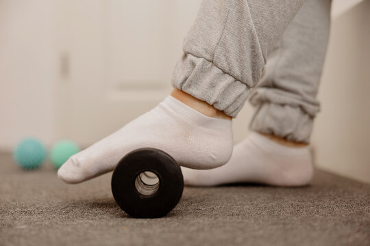 Woman Doing Flatfoot Correction Gymnastic Exercise Using Massage Roller. Myofascial Relaxation Of Foot Muscles. Hallux Valgus. Pain. Identification Of Flat Feet. Self Care Practices At Home, Health.