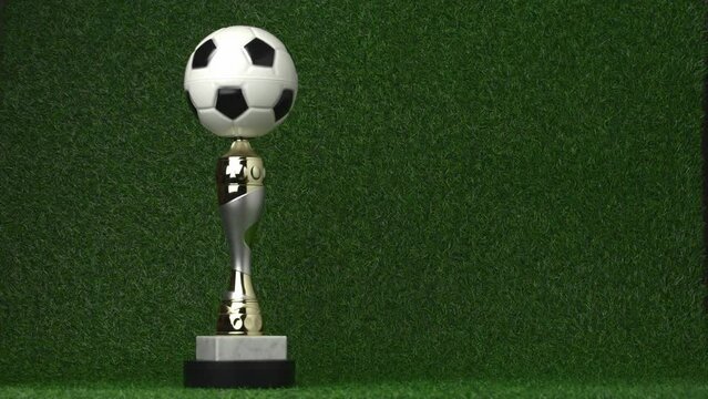 Soccer champion trophy revolves around itself with falling golden confetti. Video 4K