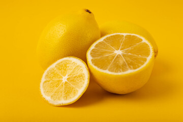 Sliced lemons on a yellow background.