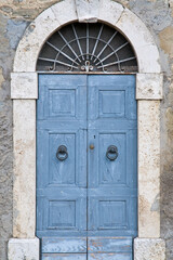 Fototapeta na wymiar Old blue wooden door. Umbria, Italy