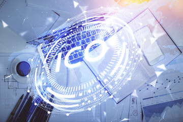 Blockchain theme hologram drawings over computer on the desktop background. Top view. Multi exposure. Concept of cryptoeconomy.