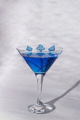 Drink in cocktail glass. Blue vibrant color.Celebration aesthetic design. Night life concept. Bar ...