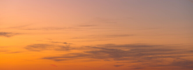 Romantic cloudy sky at sunset. Orange gradient. Sky structure, abstract nature background. copy space.