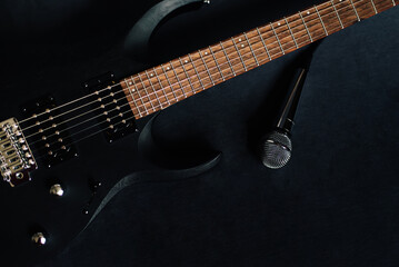 close up black electric guitar on black background concept