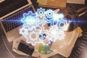 Business theme hologram drawings over computer on the desktop background. Top view. Multi exposure. Concept of international connections.