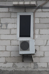 a window, a outdoor ac unit on unfinished house