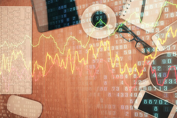 Double exposure of financial chart hologram over desktop with phone. Top view. Mobile trade platform concept.