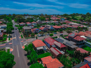Panoramic Aerial Drone view of Suburban Sydney housing, roof tops, the streets and the parks