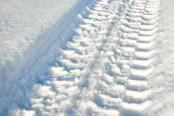 Fototapeta na wymiar Wheel tracks on the snow.