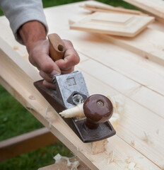 Working with hand plane. Joiner's (carpenter's) tool.