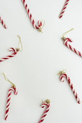 Frame of Christmas candy canes with blank copy space on white background. Holiday card template