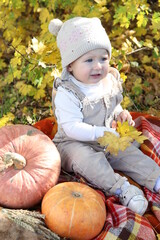 child with pumpkin
