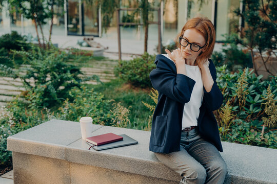 Displeased Redhead European Woman Executive Worker Suffers From Neck Pain Stiffness In Shoulders