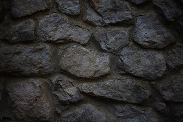 texture of a stone dark gray wall with stones of different sizes. for labels splash screens banners flyers business cards