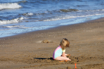 little child playing on the beach