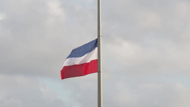 View of the Dutch flag hanging upside-down from a pole - a symbol of farmers' protest in Steenwijk
