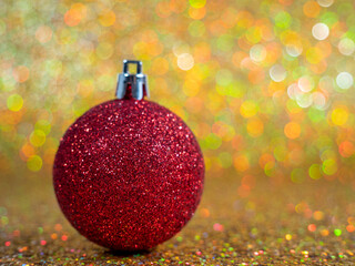 Christmas balls on a golden background. Christmas decoration with beautiful bokeh.