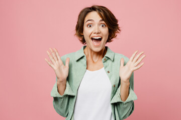 Young overjoyed happy exultant woman wear mint shirt white t-shirt look camera spread hands say wow...