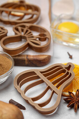 Fototapeta na wymiar Cookie cutters of different shapes and ingredients on white marble table