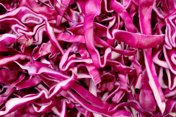 Tasty fresh shredded red cabbage as background, closeup