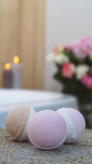 Colorful bath bombs on wicker mat in bathroom