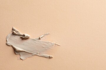 Sample of face mask on beige background, top view. Space for text