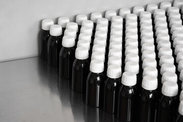Production line conveyor with plastic bottles in a factory.