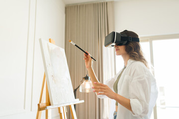 Smiling woman painting using virtual reality glasses