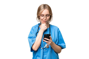 Young nurse English woman over isolated background thinking and sending a message