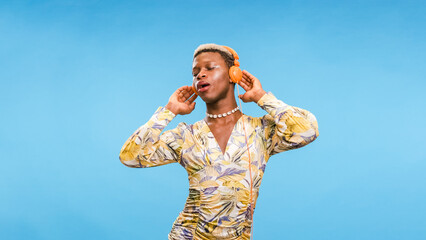 African American gay person listening to music