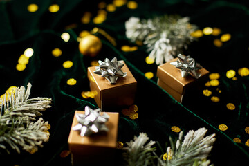Naklejka na ściany i meble Gold gift boxes with silver ribbon on shine velur green background, with christmas decorations, Flat lay. Copy space. Marry Christmas