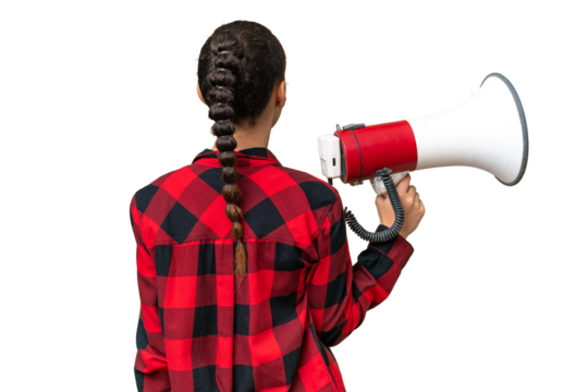 Young Arab woman over isolated background holding a megaphone and in back position
