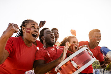African football fans having fun cheering their favorite team - Soccer sport entertainment concept - 542171722