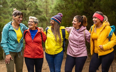 Happy women with different ages and ethnicities having fun in the woods - Adventure and travel...
