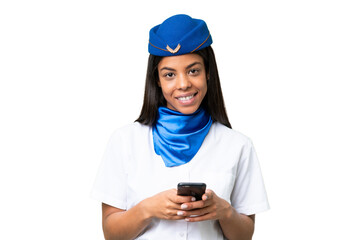 Airplane stewardess African american woman over isolated background sending a message with the mobile