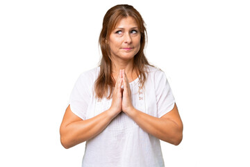 Middle-aged caucasian woman over isolated background scheming something