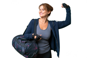 Middle-aged sport woman with sport bag over isolated background doing strong gesture
