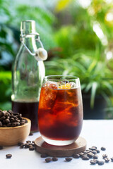 A refreshing glass of homemade cold brew coffee on bright green background