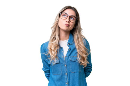 Young Uruguayan woman over isolated background and looking up