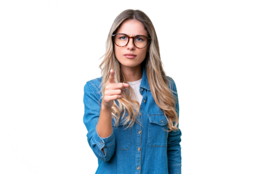 Young Uruguayan woman over isolated background frustrated and pointing to the front - Powered by Adobe