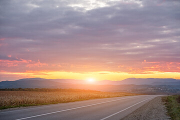 Fototapeta na wymiar empty asphalt road in sunset time with magic sky