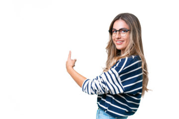 Young Uruguayan woman over isolated background pointing back