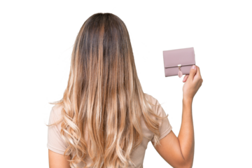Young Uruguayan woman holding a wallet over isolated background in back position