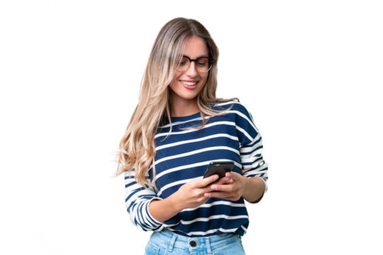 Young Uruguayan woman over isolated background sending a message with the mobile