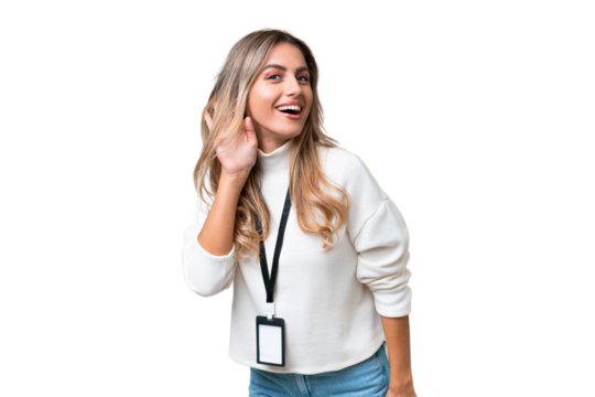 Young Uruguayan woman with ID card over isolated background listening to something by putting hand on the ear