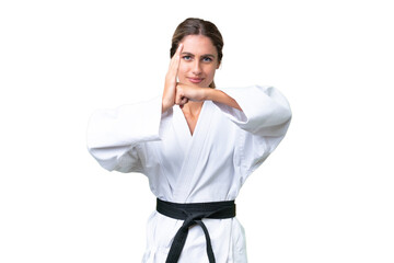 Young Uruguayan woman over isolated background doing karate and saluting