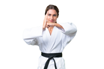 Young Uruguayan woman over isolated background doing karate and saluting