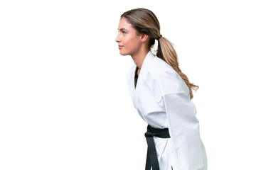 Young Uruguayan woman over isolated background doing karate and saluting