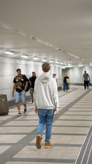Obraz premium Teenager walking alone in tunnel - Stock Photo