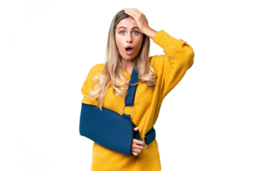 Young Uruguayan woman with broken arm and wearing a sling over isolated background with surprise expression